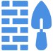 A blue brick wall with a shovel next to it.